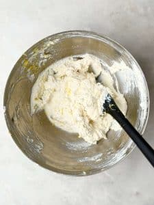 Lemon ricotta Parmesan mixture in a metal bowl for topping creamy lasagna soup.