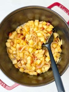 Caramelized apples and onions forming the base for cabbage and sausage skillet
