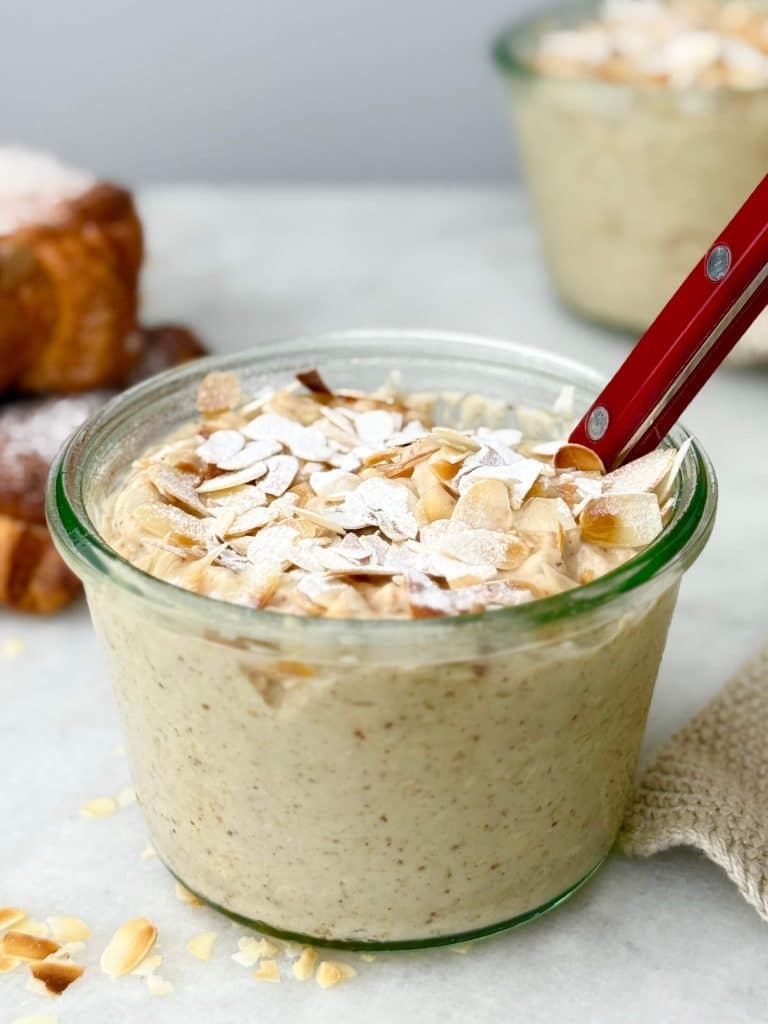 Almond croissant overnight oats topped with toasted sliced almonds.