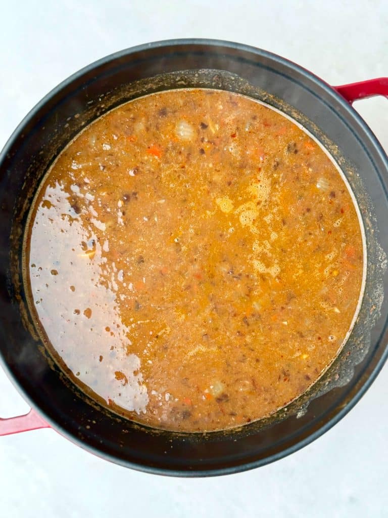Creamy blended black bean soup in a Dutch oven.