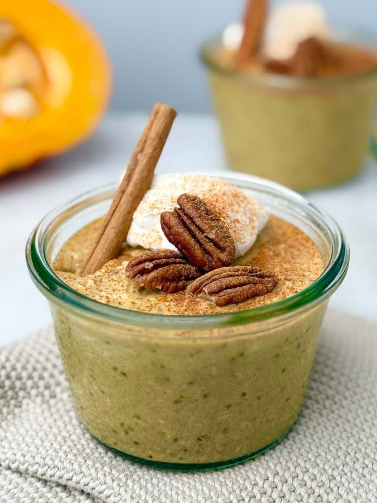Pumpkin overnight oats with chia seeds topped with pecans and cinnamon.