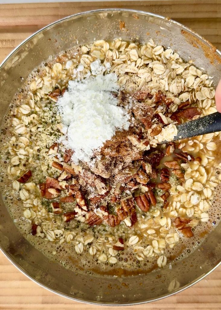 Rolled oats, pecans, hemp hearts, spices, and baking powder added to the wet mixture to make pecan pie baked oatmeal.