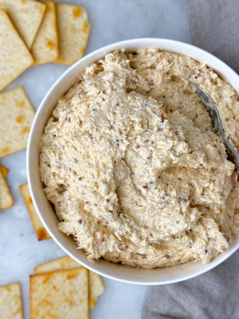 Creamy honey mustard chicken salad with shredded chicken and a tangy, protein-rich dressing served with crackers.