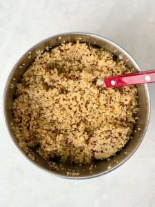 Fluffy cooked quinoa made with bone broth for the harvest quinoa salad.