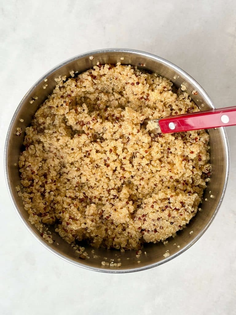 Fluffy cooked quinoa made with bone broth for the harvest quinoa salad.