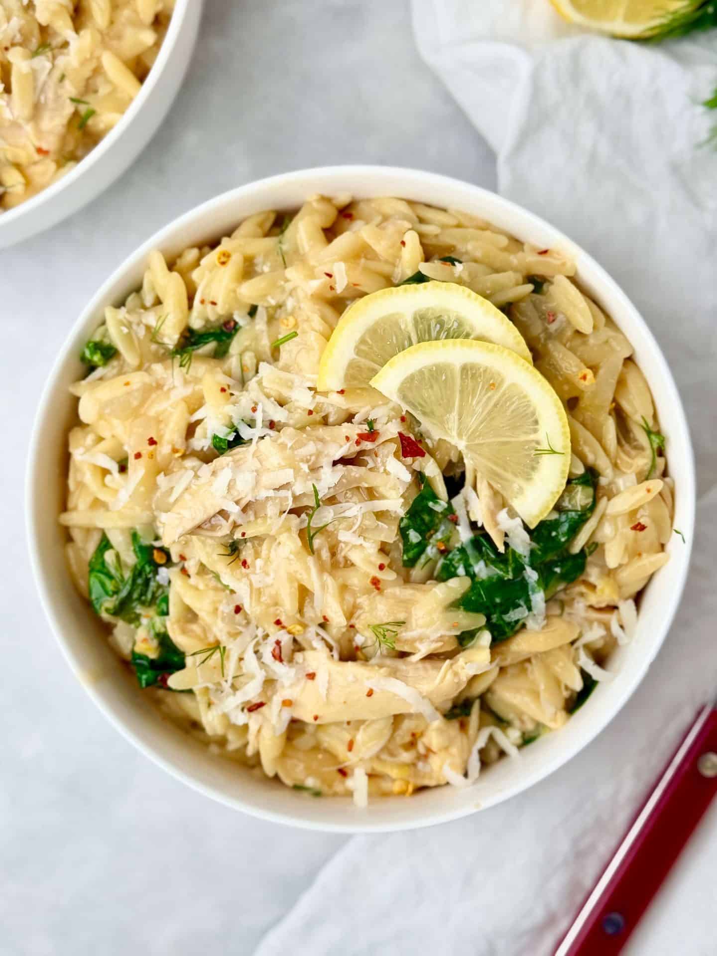 One-pot lemon chicken orzo with shredded rotisserie chicken, wilted spinach, dill, and grated parmesan.