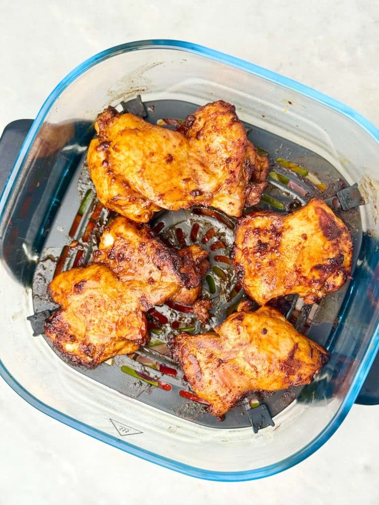Air fryer chipotle chicken thighs cooked until juicy and lightly charred for a copycat Chipotle burrito bowl.