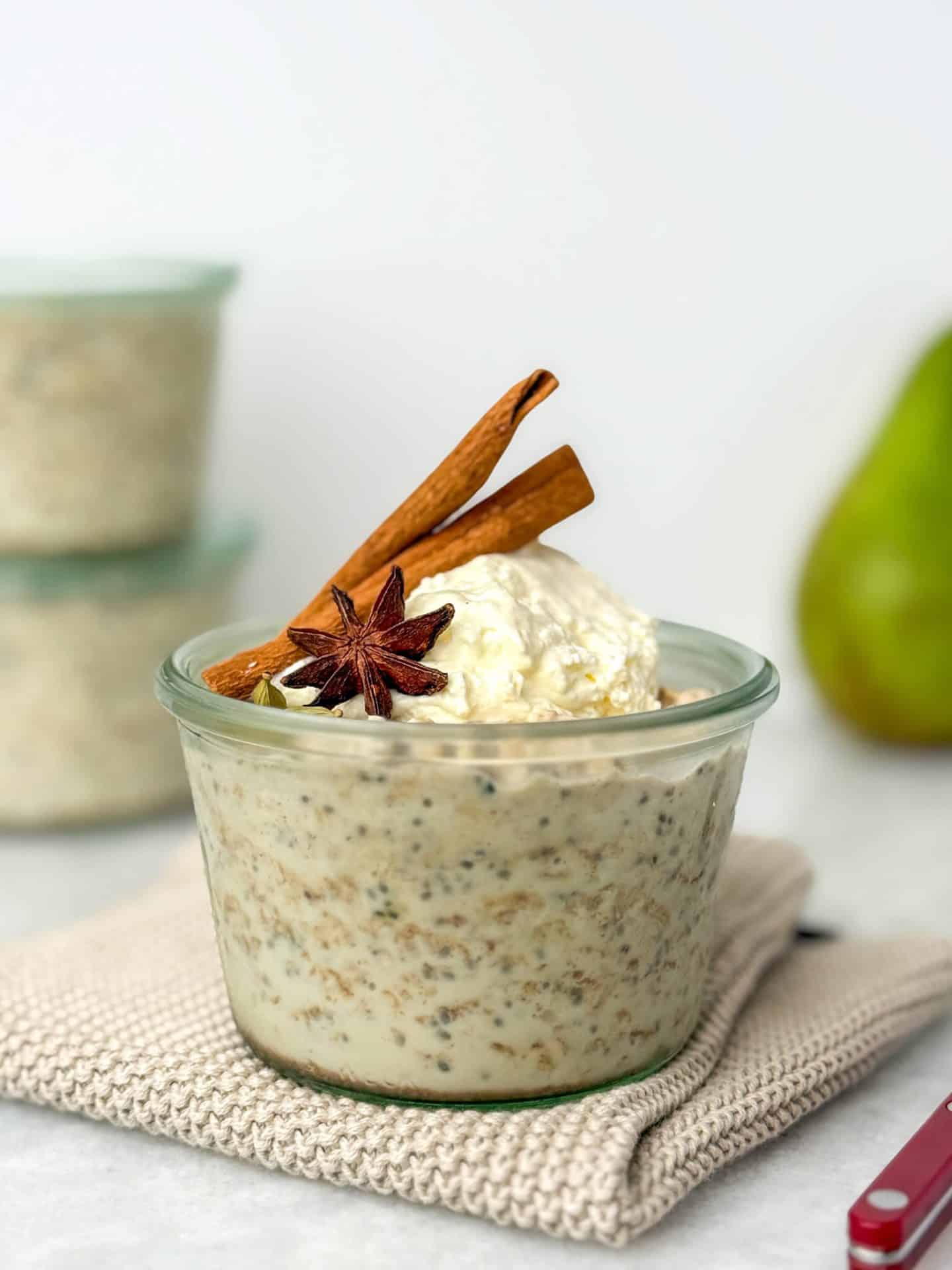 High-protein chai overnight oats in a glass jar topped with yogurt and warm chai spices.