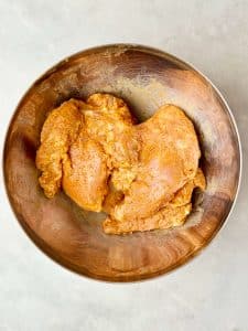 Chicken thighs marinated in shawarma seasoning, yogurt, and lemon juice for air fryer chicken shawarma.