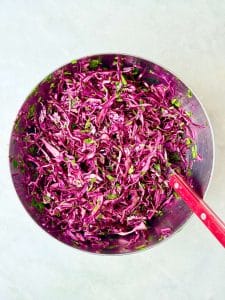 Quick shredded red cabbage salad with parsley, olive oil, and vinegar for chicken shawarma bowls.