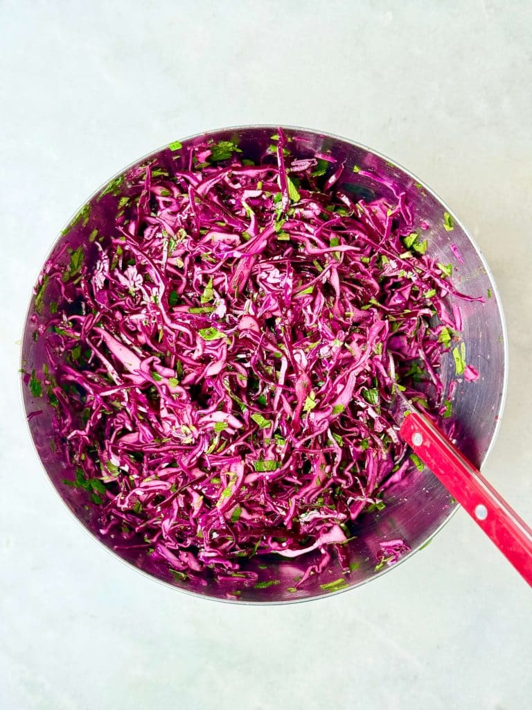 Quick shredded red cabbage salad with parsley, olive oil, and vinegar for chicken shawarma bowls.