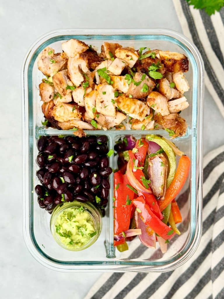 Copycat Chipotle burrito bowl meal prep with air fryer chipotle chicken, black beans, fajita vegetables, and guacamole.