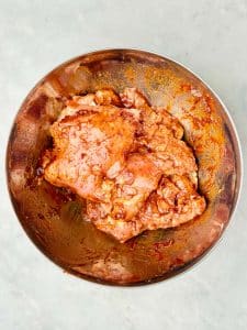 Chipotle-marinated boneless skinless chicken thighs coated in a smoky adobo sauce for a copycat Chipotle burrito bowl.