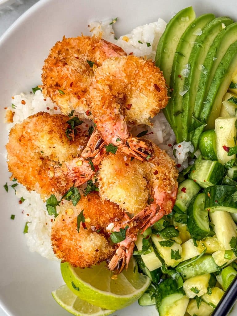 Close-up of coconut shrimp bowls featuring golden air fryer coconut shrimp and fresh toppings