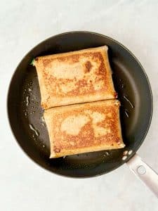 Crispy pan-fried spanakopita wraps cooked until golden brown