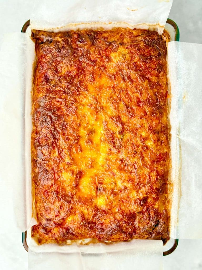 Overhead view of a healthy high protein egg casserole fresh from the oven with a crisp, golden surface.