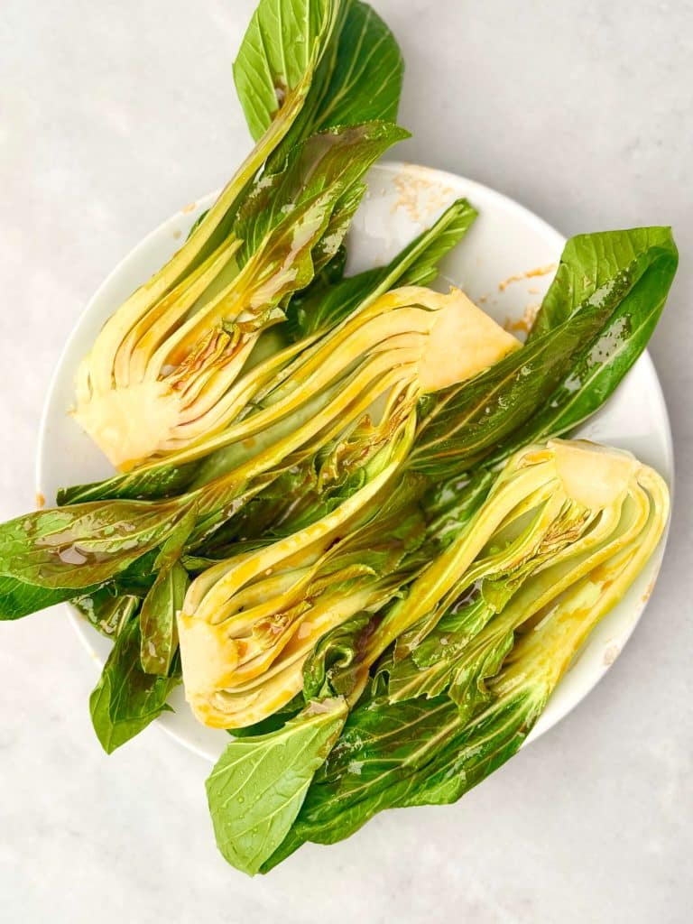 Soy glazed baby bok choy roasted until tender and lightly caramelized