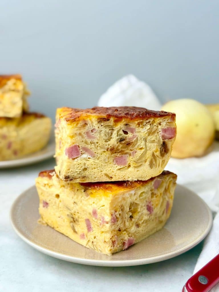 Close-up of a high protein breakfast casserole with eggs, ham, and cheese baked until lightly golden.