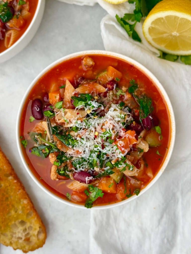High protein minestrone soup served with crusty bread, finished with lemon and Parmesan