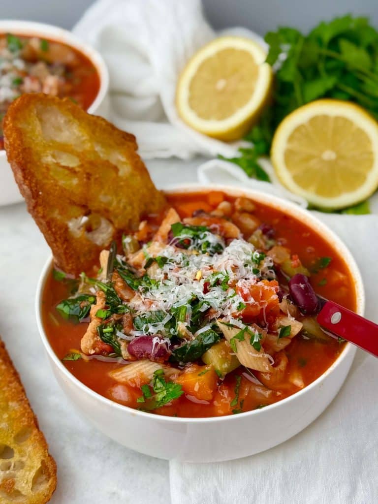 High protein minestrone soup with chicken sausage, pasta, vegetables, and fresh herbs