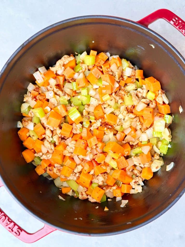 Chicken sausage sautéed with onion, carrots, and celery for high protein minestrone soup