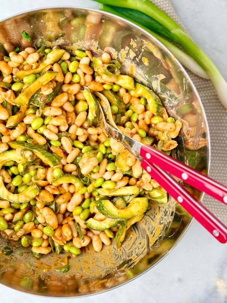 Miso bean salad with white beans, edamame, cucumber, and green onions tossed in a creamy peanut miso sauce.