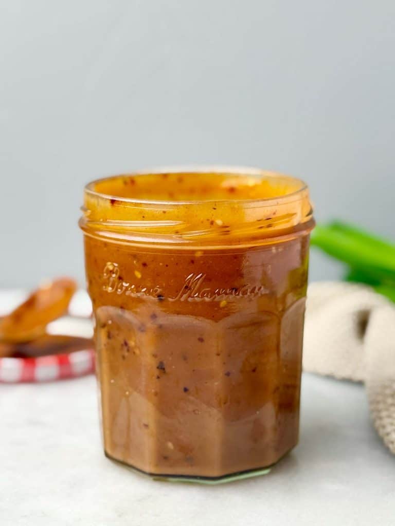 Spicy peanut miso dressing made with peanut butter, white miso, chili oil, and rice vinegar in a small glass jar.