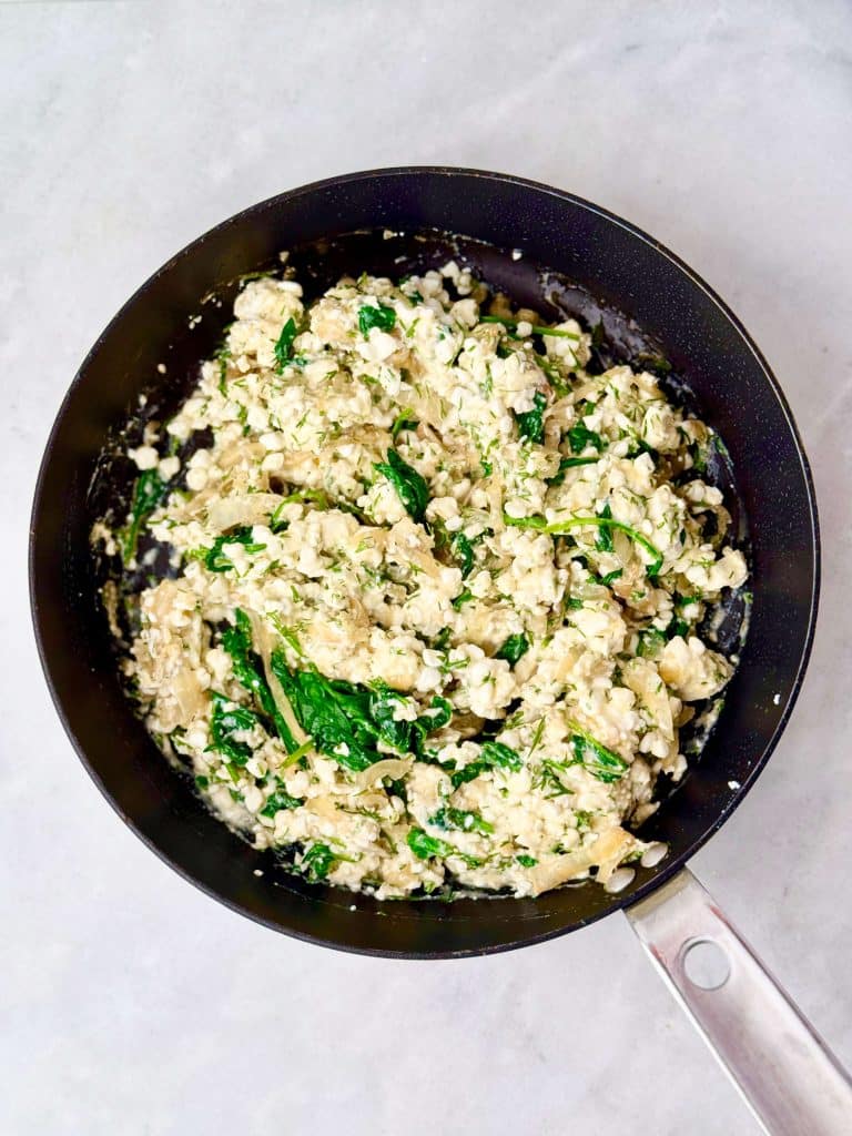 Creamy spinach and feta filling mixed together for a high-protein spanakopita wrap