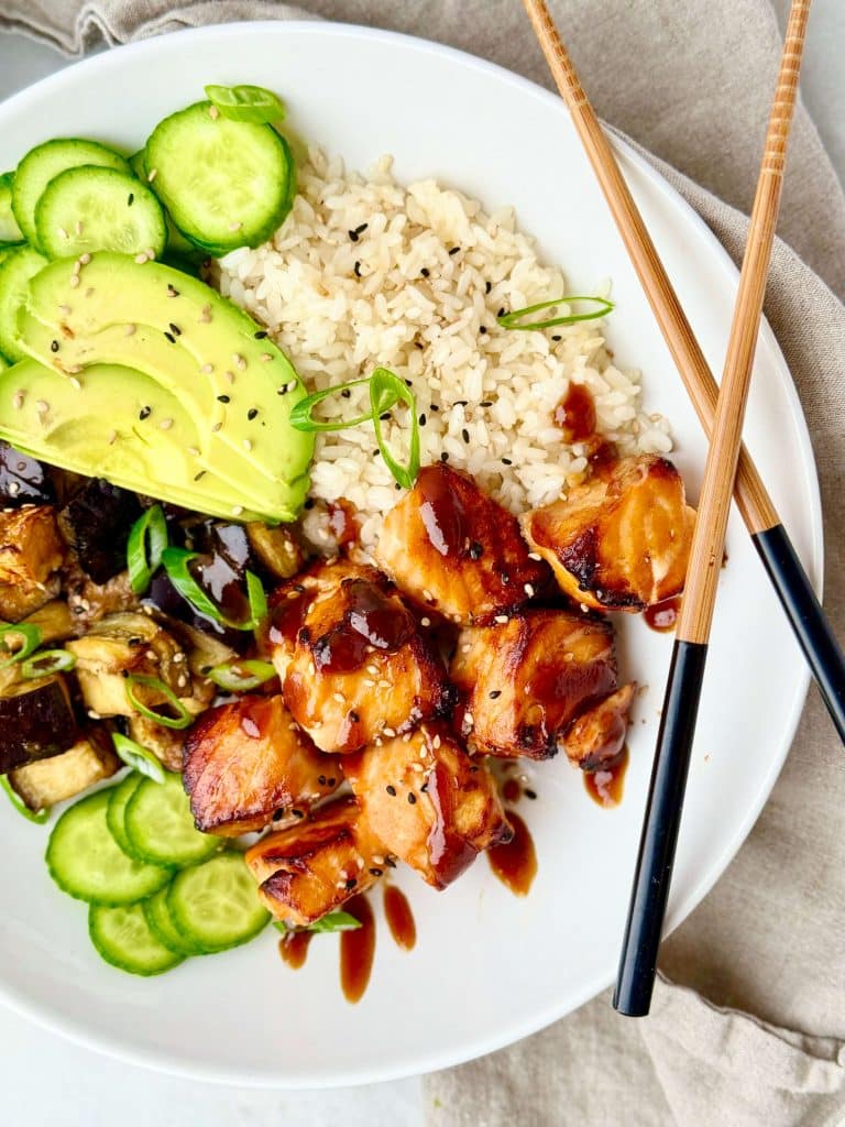 Air fryer miso glazed salmon bowl topped with green onions and sesame seeds