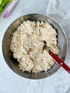 Velvety Round Swamp chicken salad recipe in a mixing bowl, showing smooth shredded consistency.