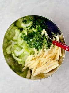 Thinly sliced celery, julienned apple, and fresh parsley for celery apple slaw.