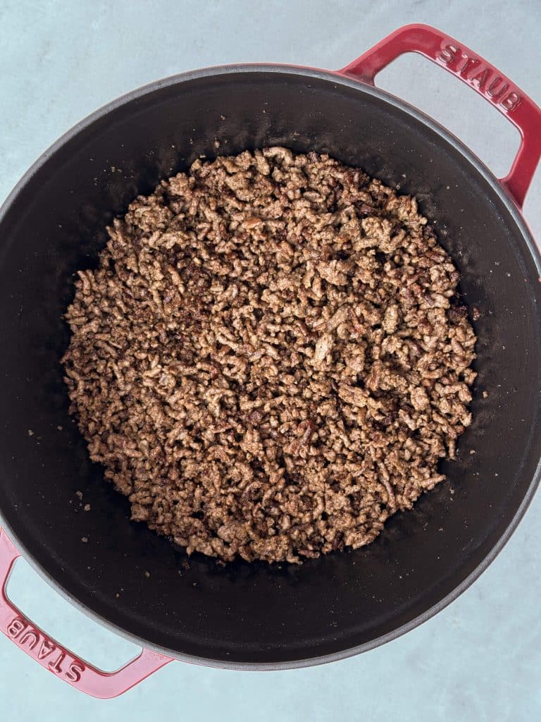 Lean ground beef browned in a large pot as the base for unstuffed cabbage soup