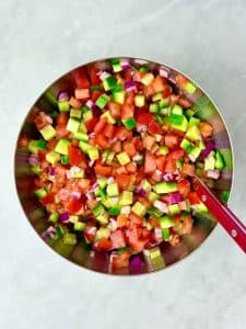 Kachumber-style salad with finely chopped cucumber, tomato, and red onion for chicken tikka bowls