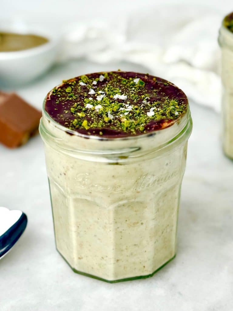 High-protein Dubai chocolate overnight oats topped with dark chocolate and ground pistachios