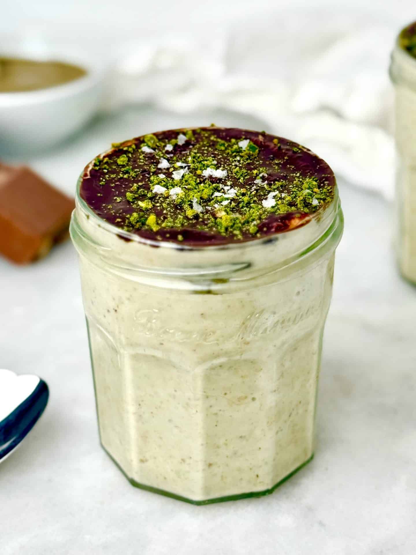 High-protein Dubai chocolate overnight oats topped with dark chocolate and ground pistachios