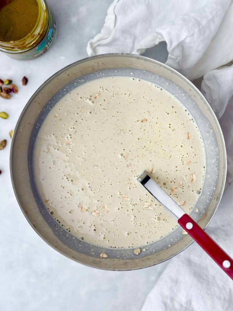 Creamy blended pistachio overnight oats mixture made with milk, Greek yogurt, protein powder, and pistachios