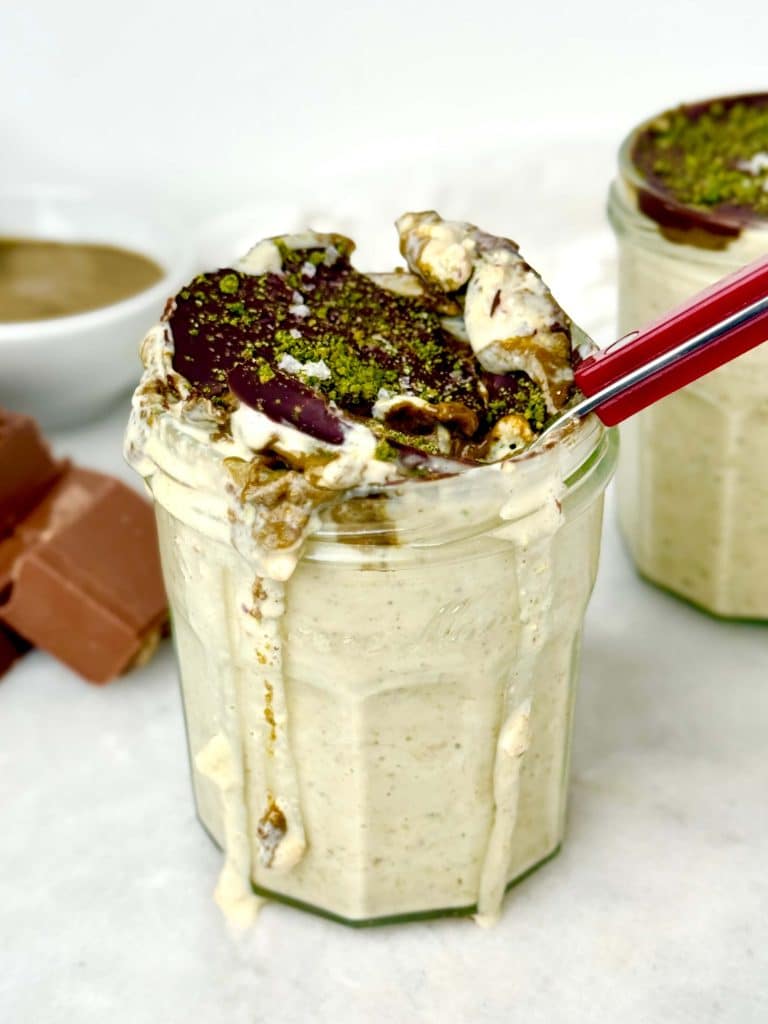 Dubai chocolate pistachio overnight oats with pistachio butter layer and cracked chocolate shell