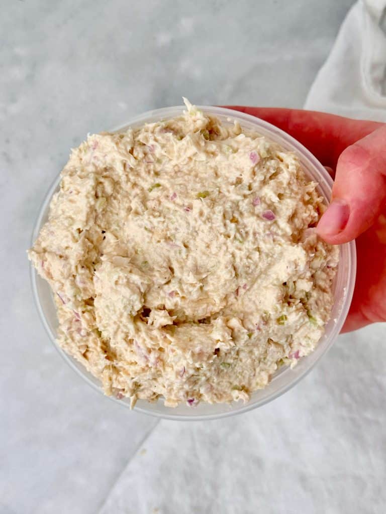 Homemade Round Swamp Farm chicken salad recipe in a storage container, creamy and deli-style.