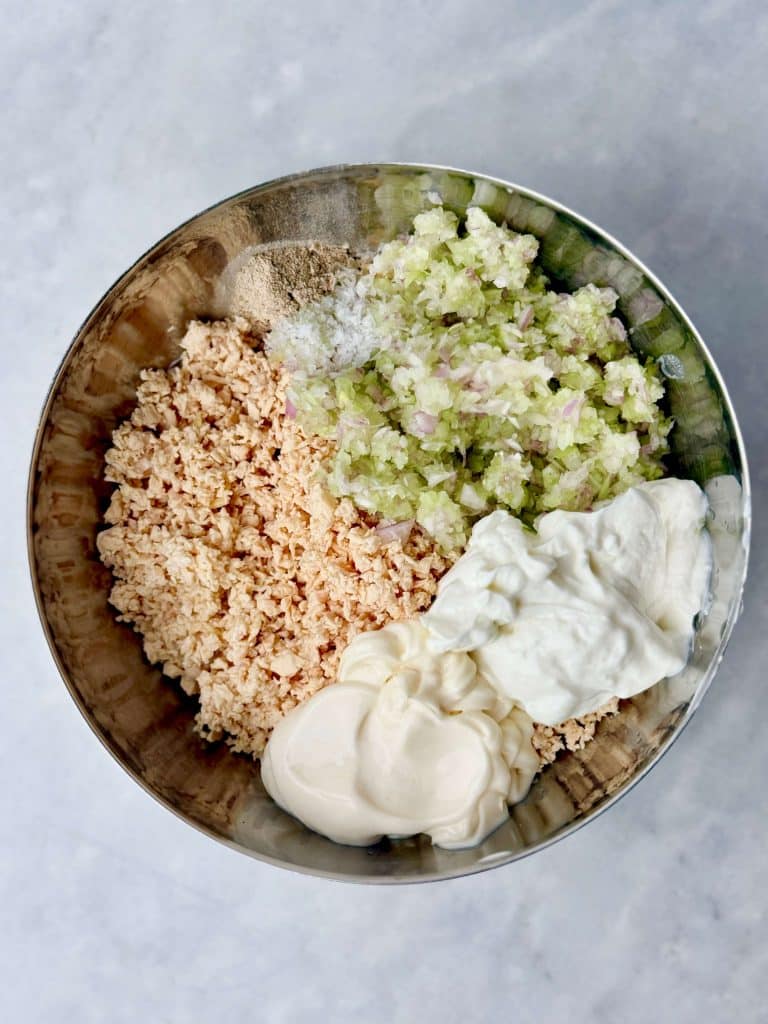 Round Swamp Farm chicken salad ingredients including shredded rotisserie chicken, celery, shallot, mayonnaise, and Greek yogurt.