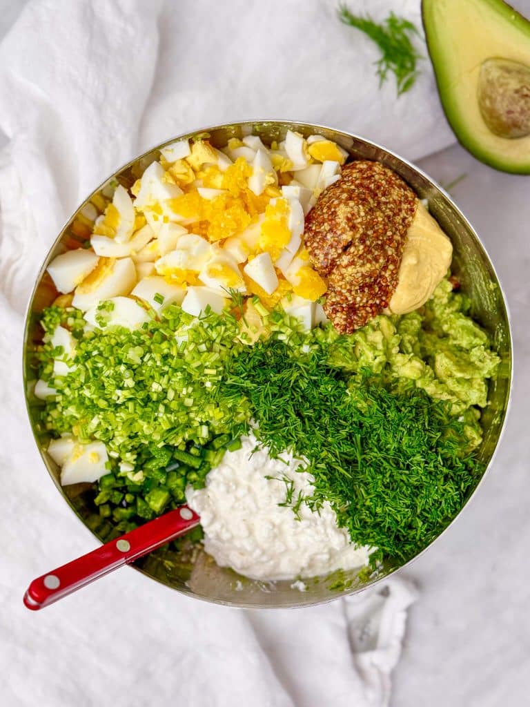 chopped boiled eggs, mashed avocado, cottage cheese, fresh dill, chives, Dijon and grainy mustard in a large mixing bowl before combining