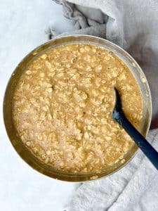 Banana bread baked oats batter mixed in a bowl with a spatula