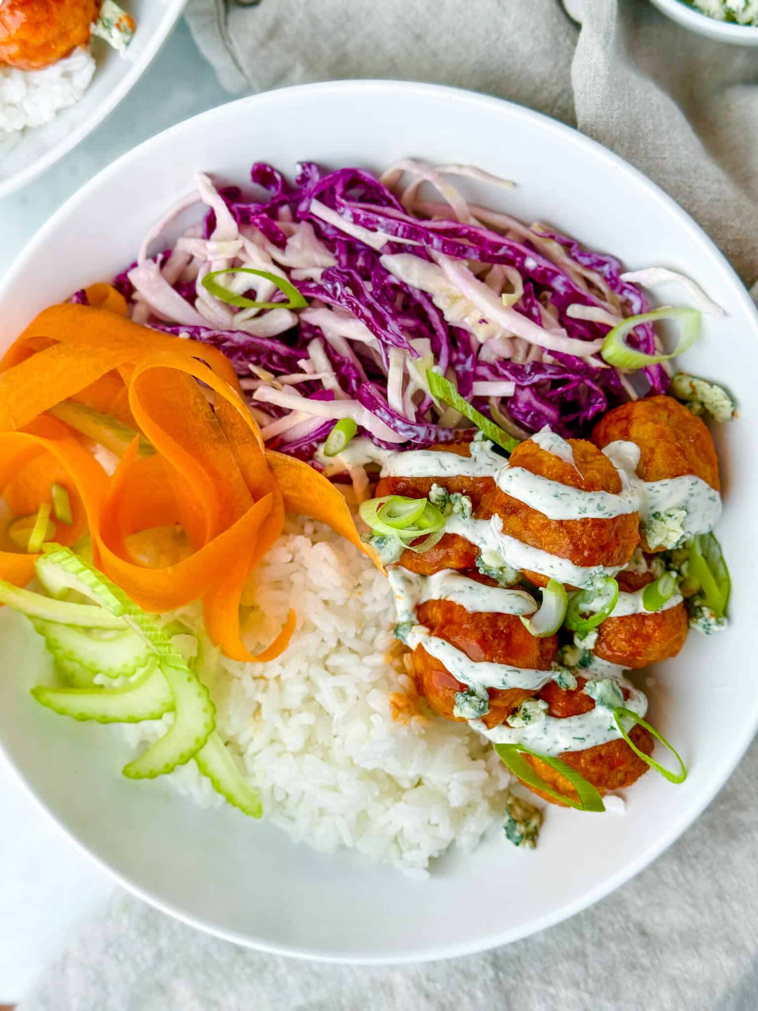 Air fryer buffalo chicken meatball bowls with ranch, carrots, and rice