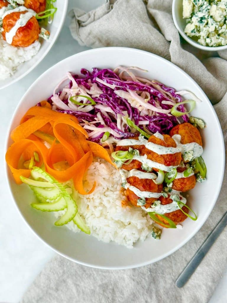 Buffalo chicken meatball bowl with rice, cabbage slaw, and ranch drizzle