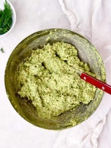 Whipped green goddess chicken salad showing velvety, mousse-like texture in a mixing bowl