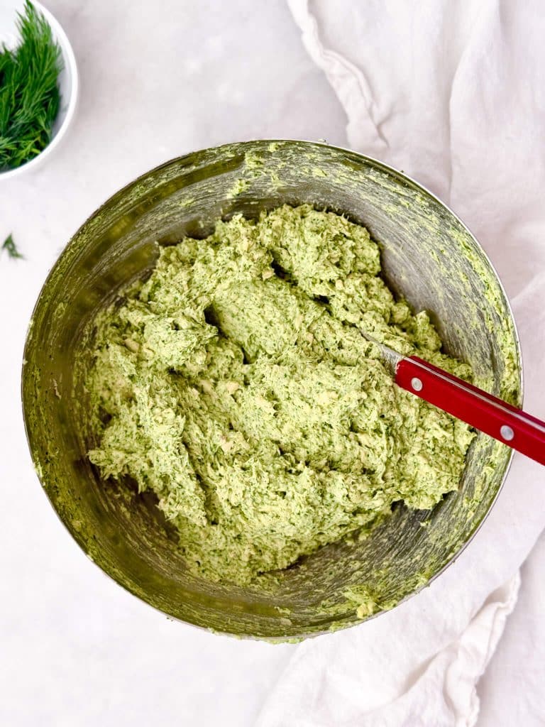 Whipped green goddess chicken salad showing velvety, mousse-like texture in a mixing bowl