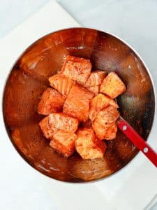 Cubed salmon tossed in spices before air frying