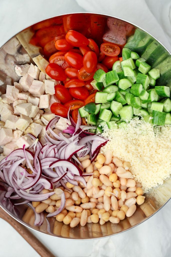 Bean salad ingredients separated in a large bowl before tossing