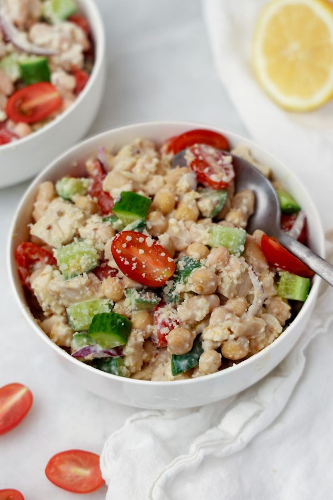 Caesar dense bean salad with chickpeas and white beans in a bowl