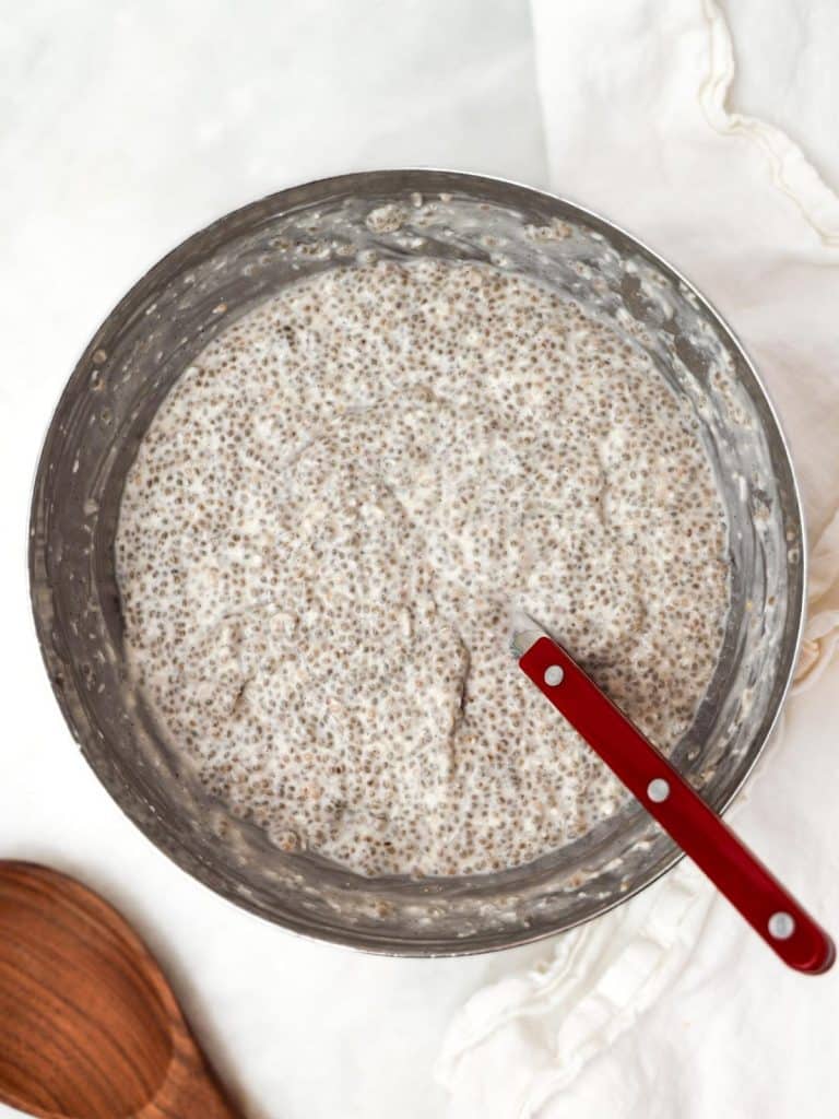 Thick set coconut chia seed pudding in a bowl ready to divide into jars