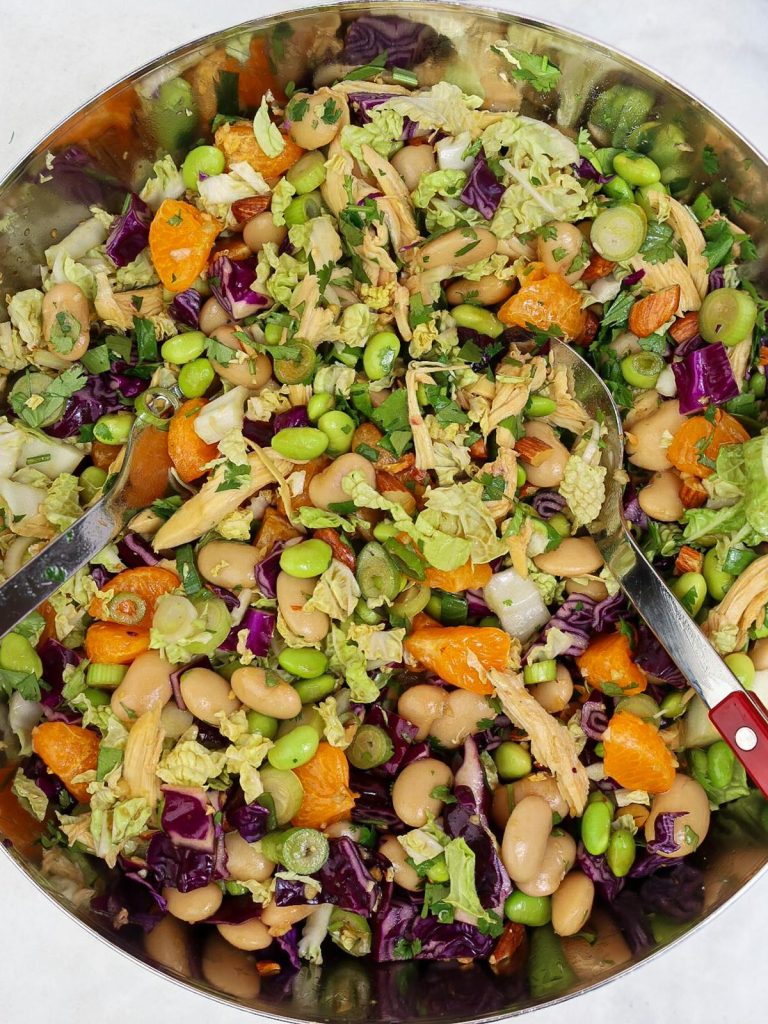 High protein dense bean salad with chicken tossed in a large mixing bowl ready to serve